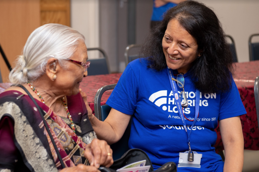 Shaila sitting with an elderly service user