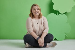 A woman sits on the floor