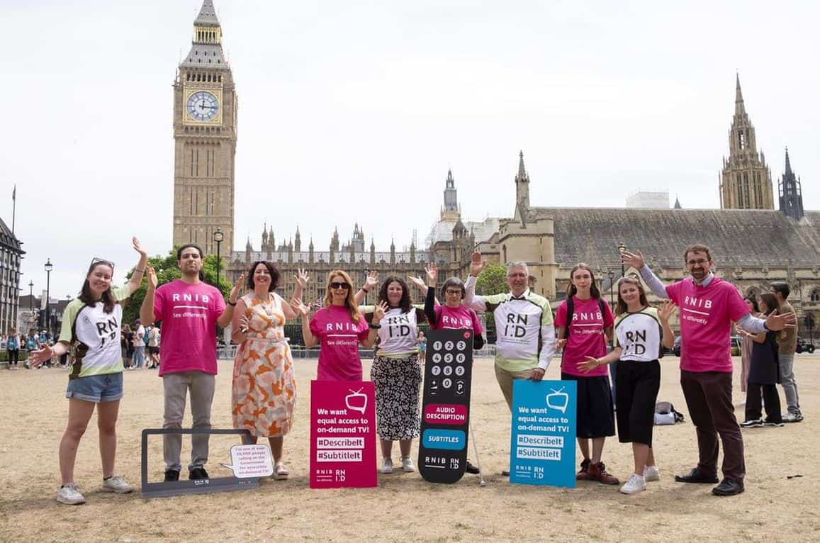 A group of campaigners with placards standing in front of the Houses of Parliament and Big Ben.