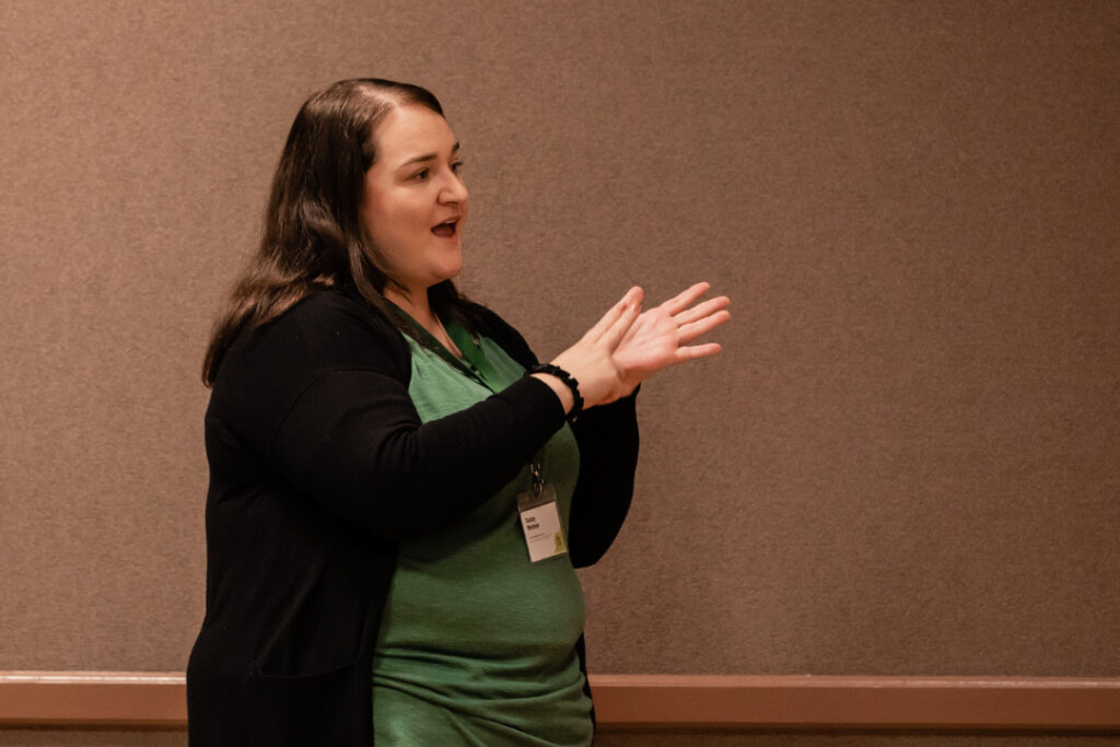 A woman using British Sign Language