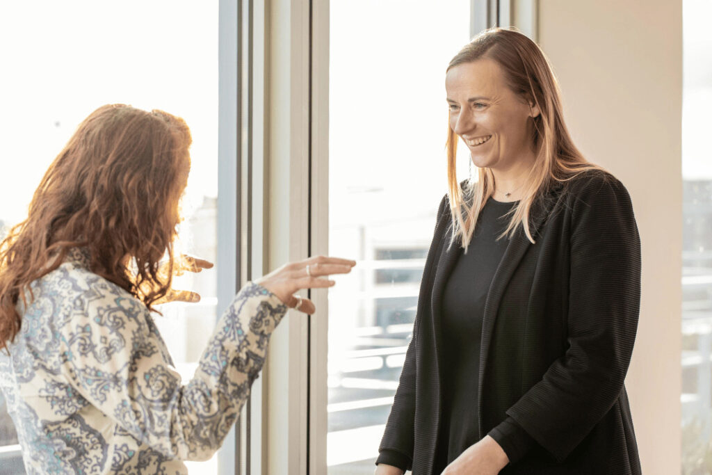 Two people speaking and smiling