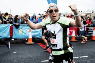Runner cheering and wearing an RNID tshirt