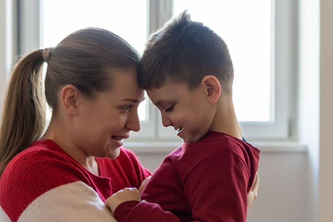 Mother and child, foreheads touching and looking at each other