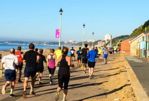 Runners in a race running along a seaside promenade