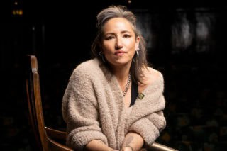 KT Tunstall seated on a wooden chair in a dark room. Credit Richard Faulks