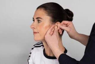 Woman having a hearing aid fitted