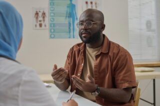 patient talking to their doctor in a hospital