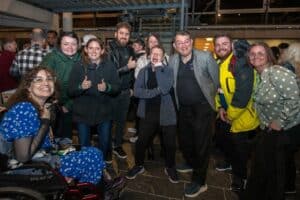 A group of RNID campaigners celebrating outside the Senedd